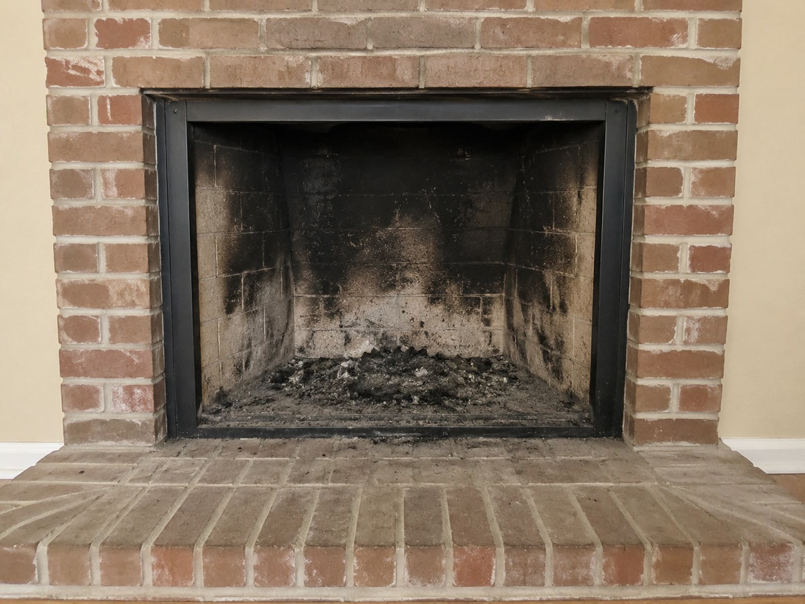 Before: firebox blackened with heavy soot and creosote buildup
