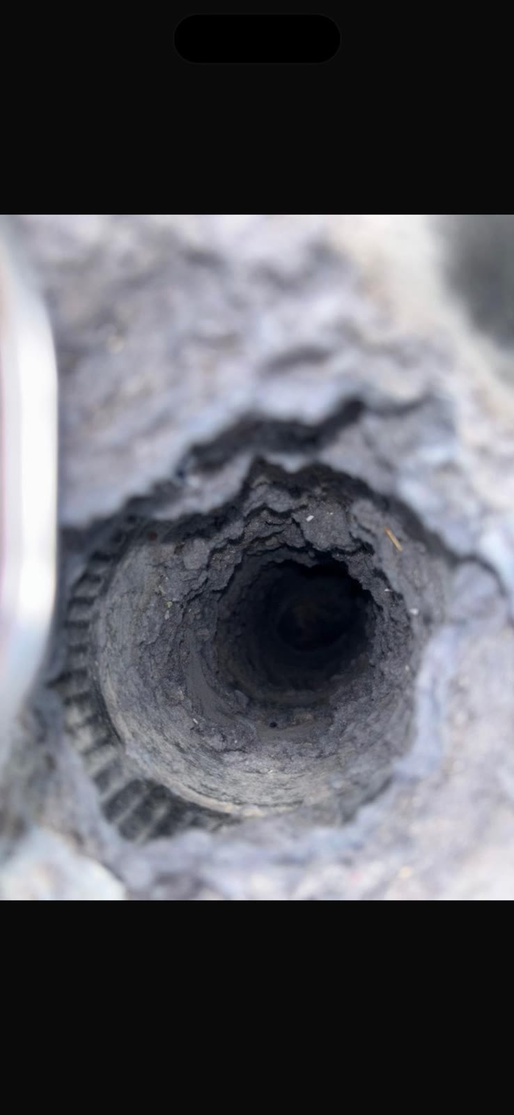 Before: dryer vent stuffed with thick lint creating fire hazard