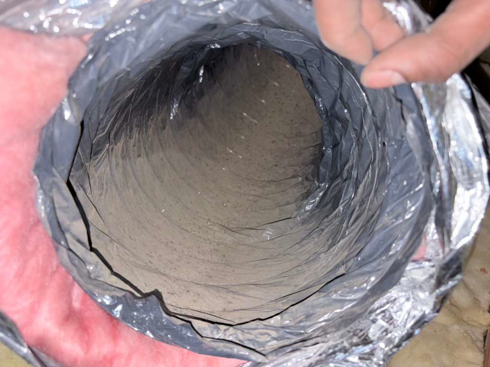 Dust-coated home air duct interior before professional Green World Air Care cleaning